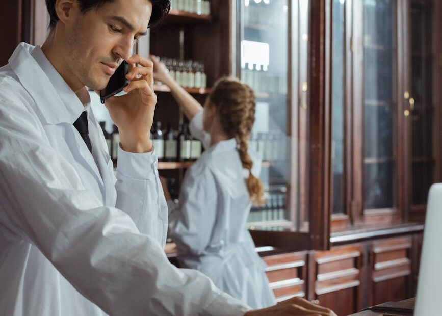 a man in white coat talking on the phone